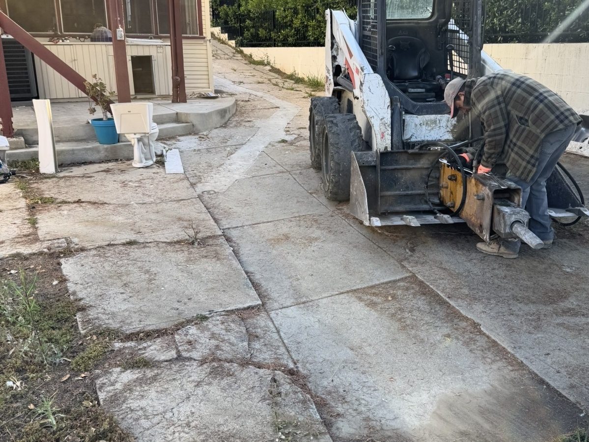 Cracked concrete driveway before removal
